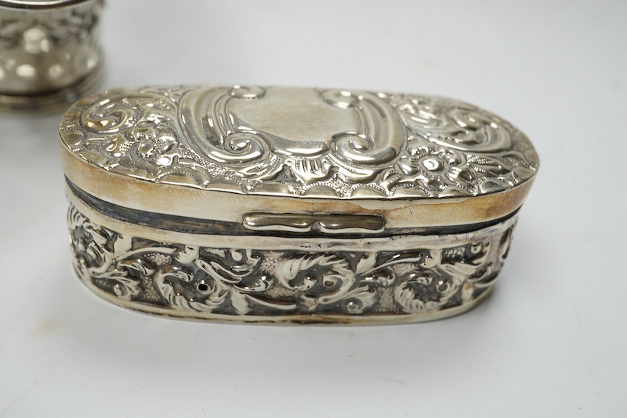 An Edwardian silver 'Reynold's Angels' silver canister, William Comyns, London, 1902, 90mm, together with a silver table perpetual lighter, silver bonbon basket and silver ring box. Condition - poor to fair